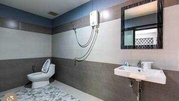 A bathroom with a toilet, a sink, and a shower.