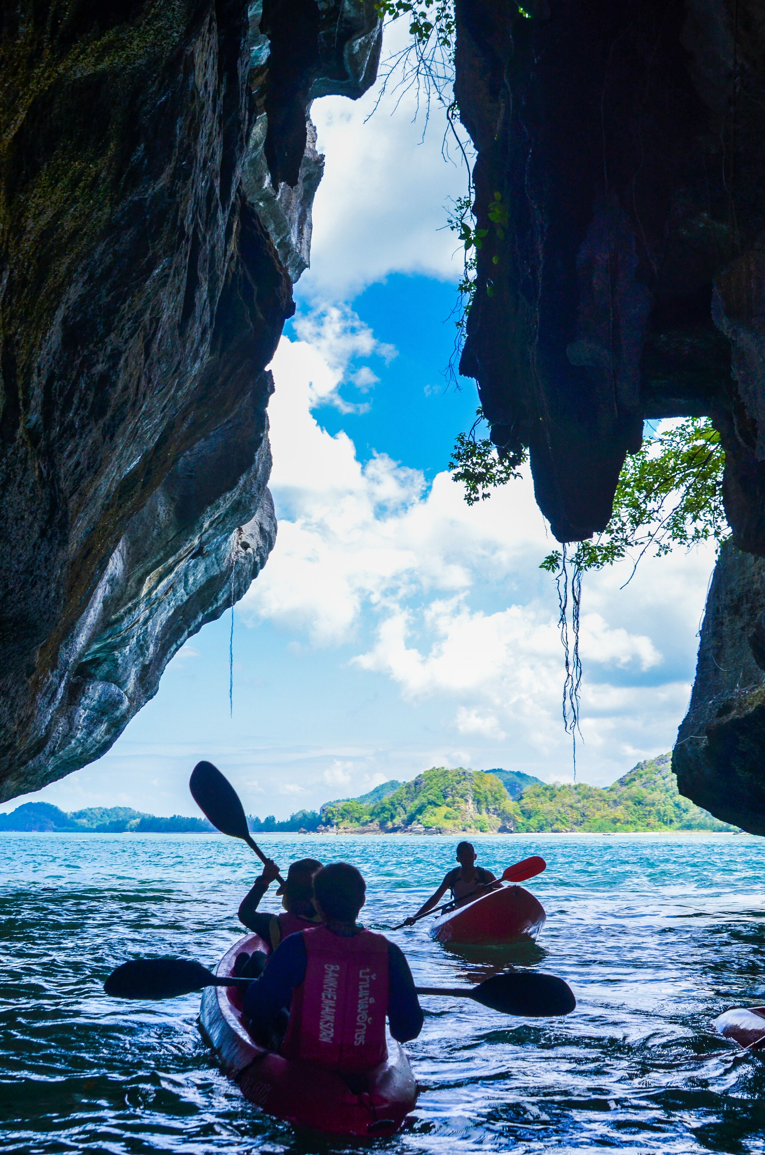 Kayakistas en un estrecho canal entre formaciones rocosas.
