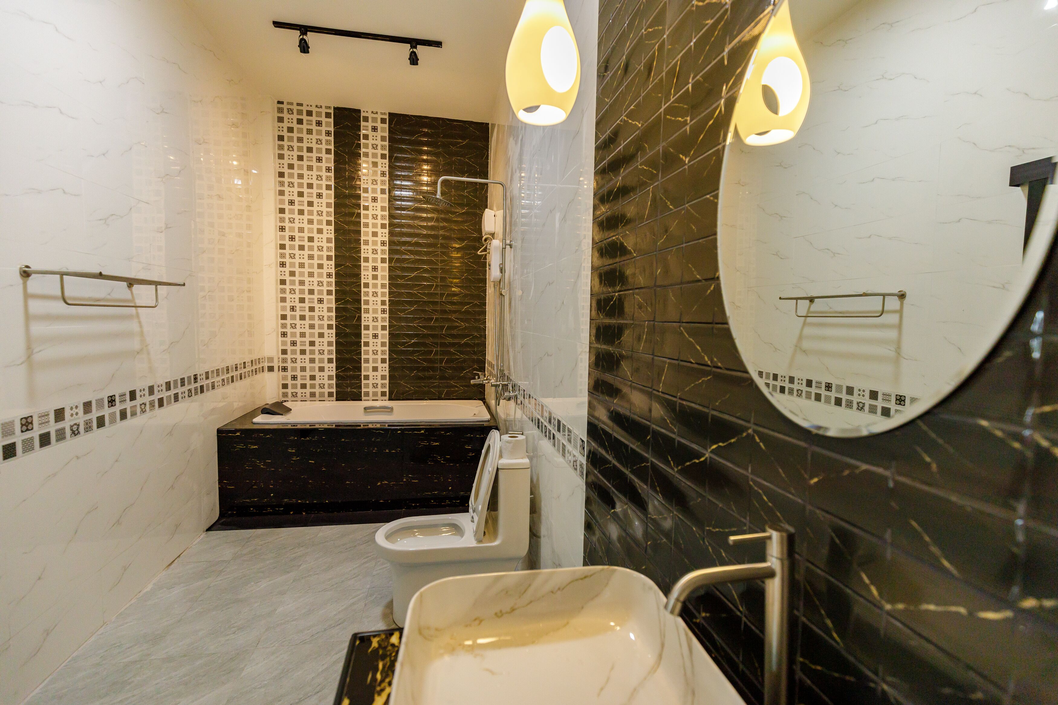 A modern bathroom with a bathtub, toilet, and sink.