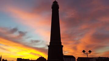 A tall, slender tower against a sunset sky.