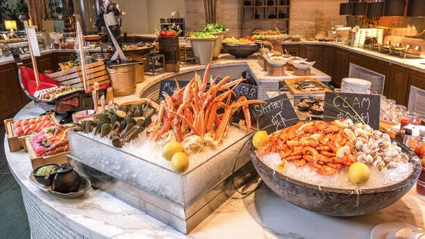 A seafood buffet with various types of seafood displayed on ice. - The Kunlun Jing An (Shanghai)