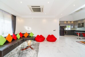 Villa Luxe | Coin séjour | Télévision à écran plat de 55 pouces avec chaînes par câble, télévision