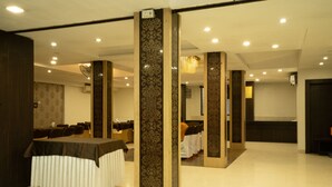 A conference room with a long table, chairs, and decorative columns.