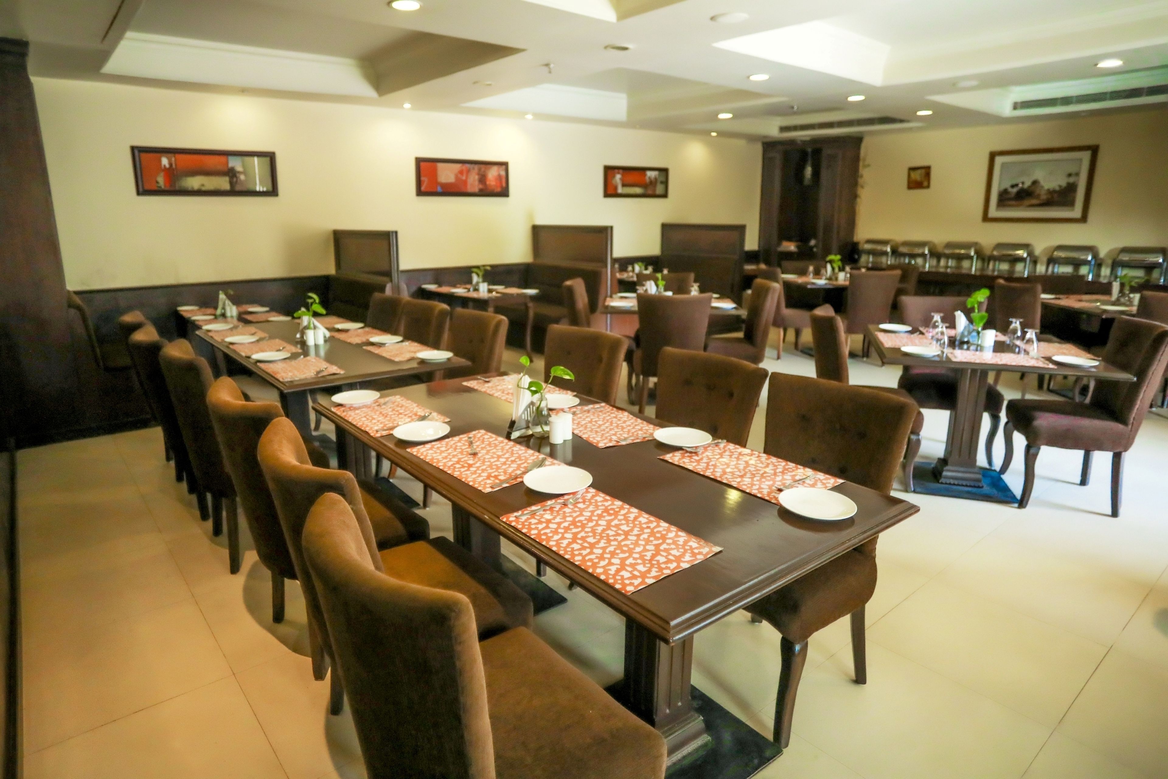 A restaurant with multiple dining tables and booths, arranged in a spacious layout.