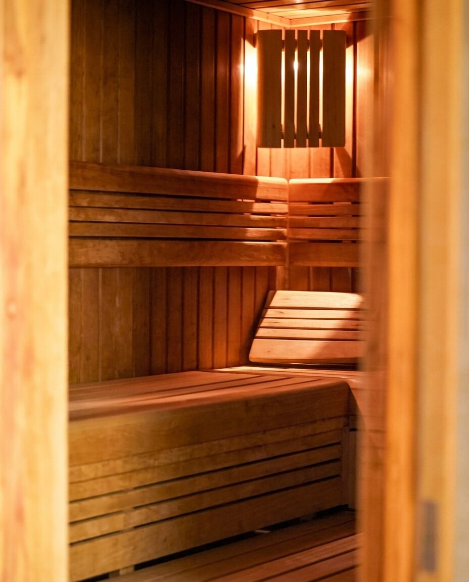 A sauna with wooden benches and slatted walls.