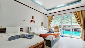 A hotel room with two beds, a large window with curtains, a view of a pool, and a ceiling with a blue accent. - Laketerrace Resort (La-ngu)