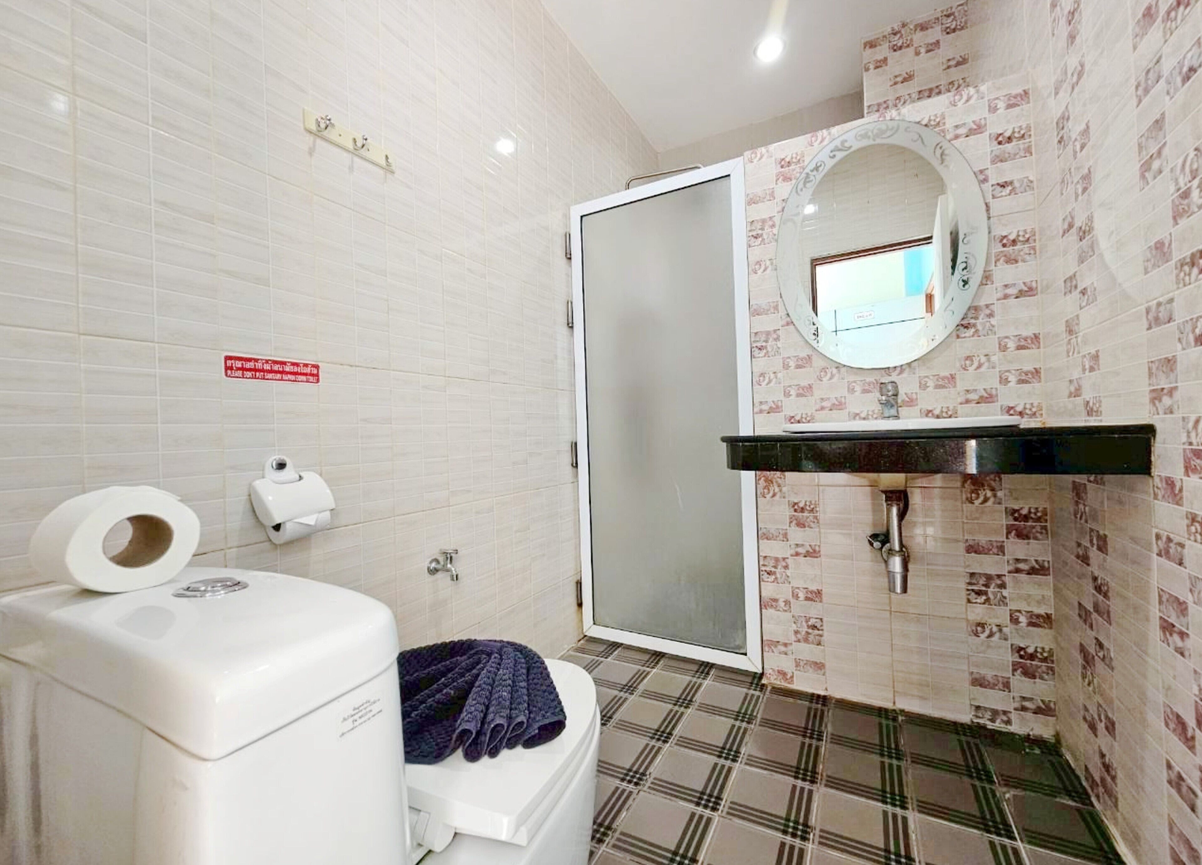 A bathroom with a toilet, a sink, and a shower.
