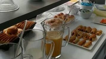 Un bufé de desayuno con diversos alimentos y bebidas.