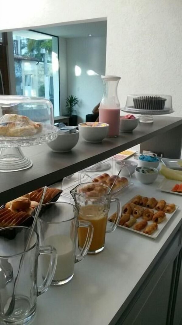 A breakfast buffet with various food items and beverages.