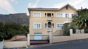A two-story building with a balcony, a garage, and a gate. - Kenwood 7 (Cape Town)