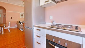 A kitchen with a stainless steel refrigerator, a stove, and a microwave. - Kenwood 7 (Cape Town)