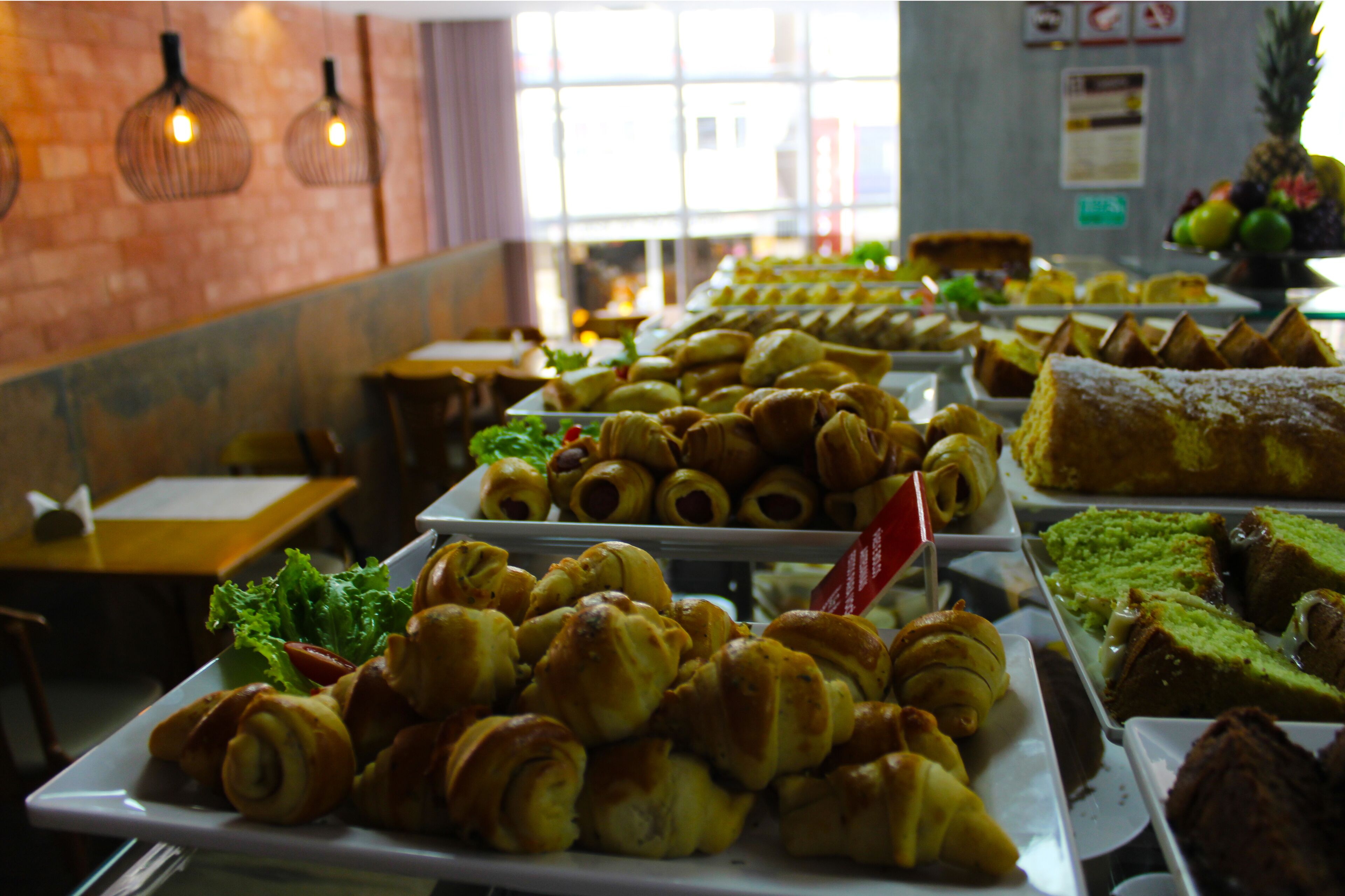 A buffet with various pastries and a pineapple on display.