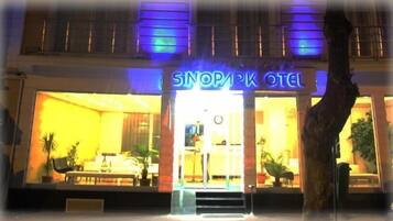 The entrance to Sinopark Hotel with a visible reception area and a staircase leading to the entrance.