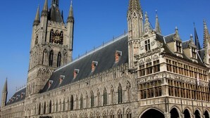 A historic building with Gothic architecture, featuring pointed arches, intricate stonework, and multiple spires. - B&B Laurus (Ypres)