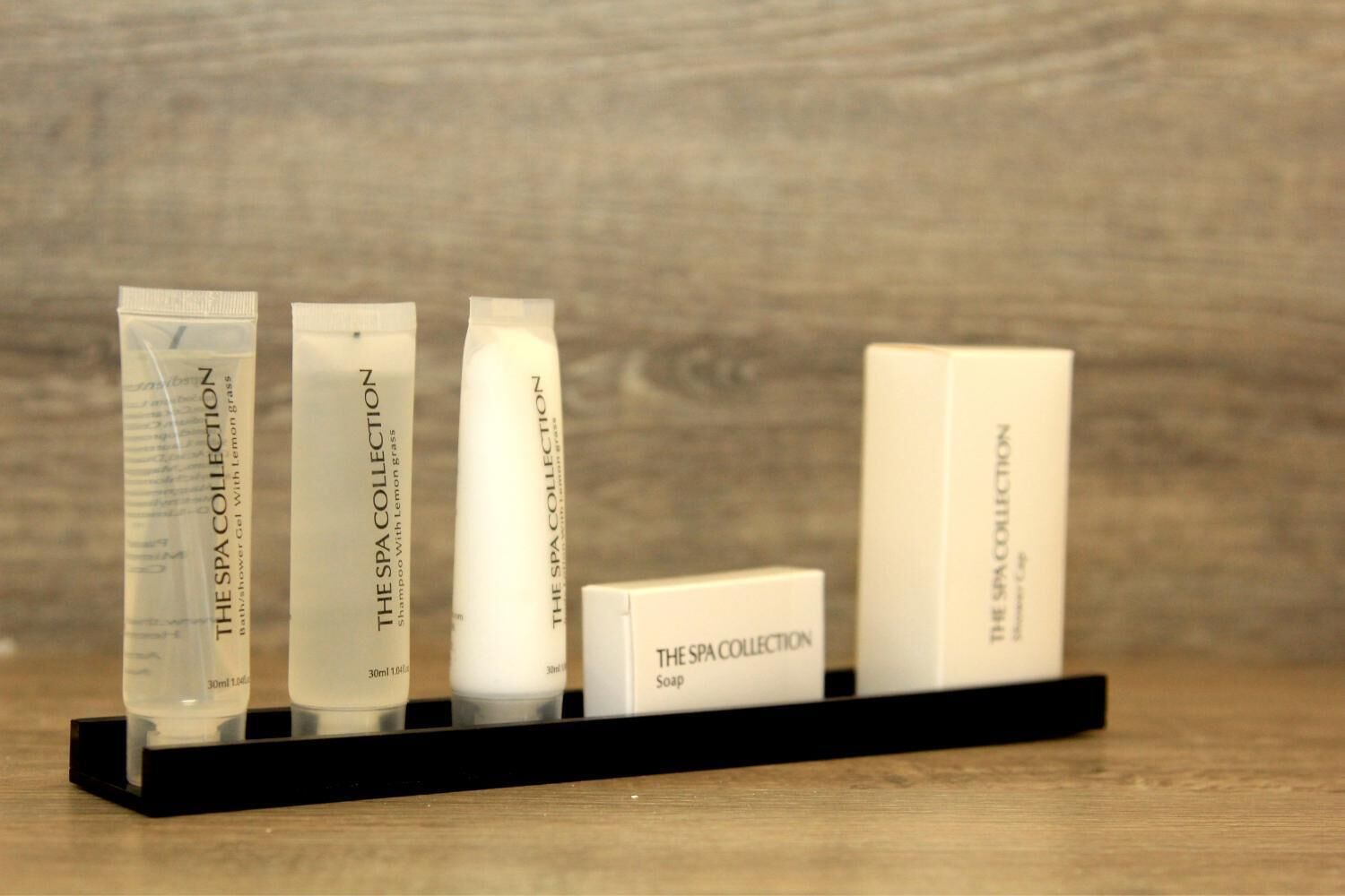 A display of spa collection products on a black stand.