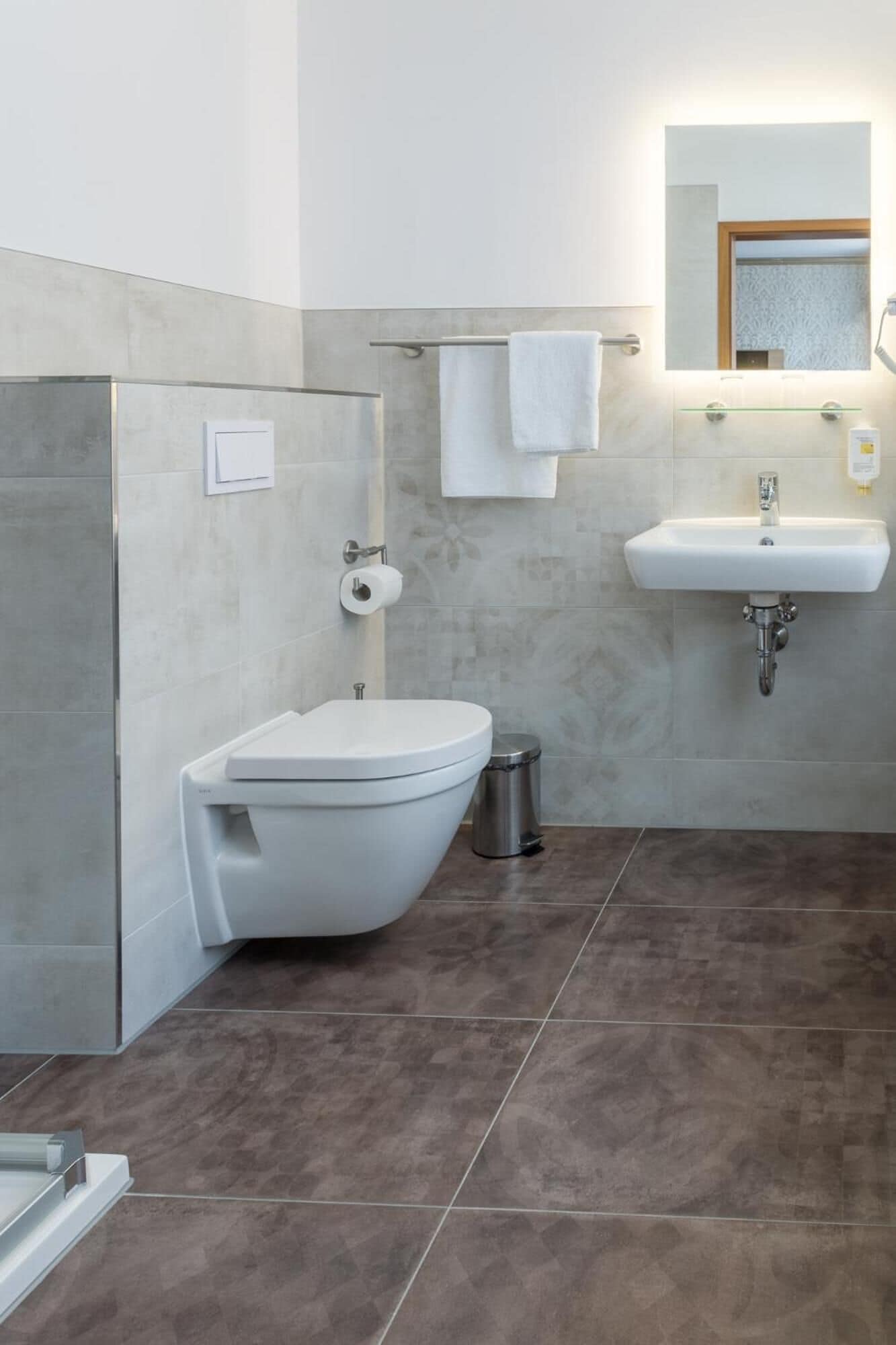 A modern bathroom with a toilet, bidet, and sink.