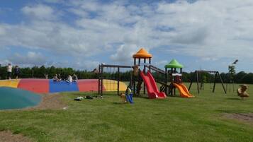 A playground with slides and climbing structures.