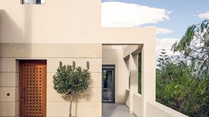 A modern building with a flat facade, a wooden door, and a small window. - Minimal Blue Villa (Markopoulo Mesogaias)