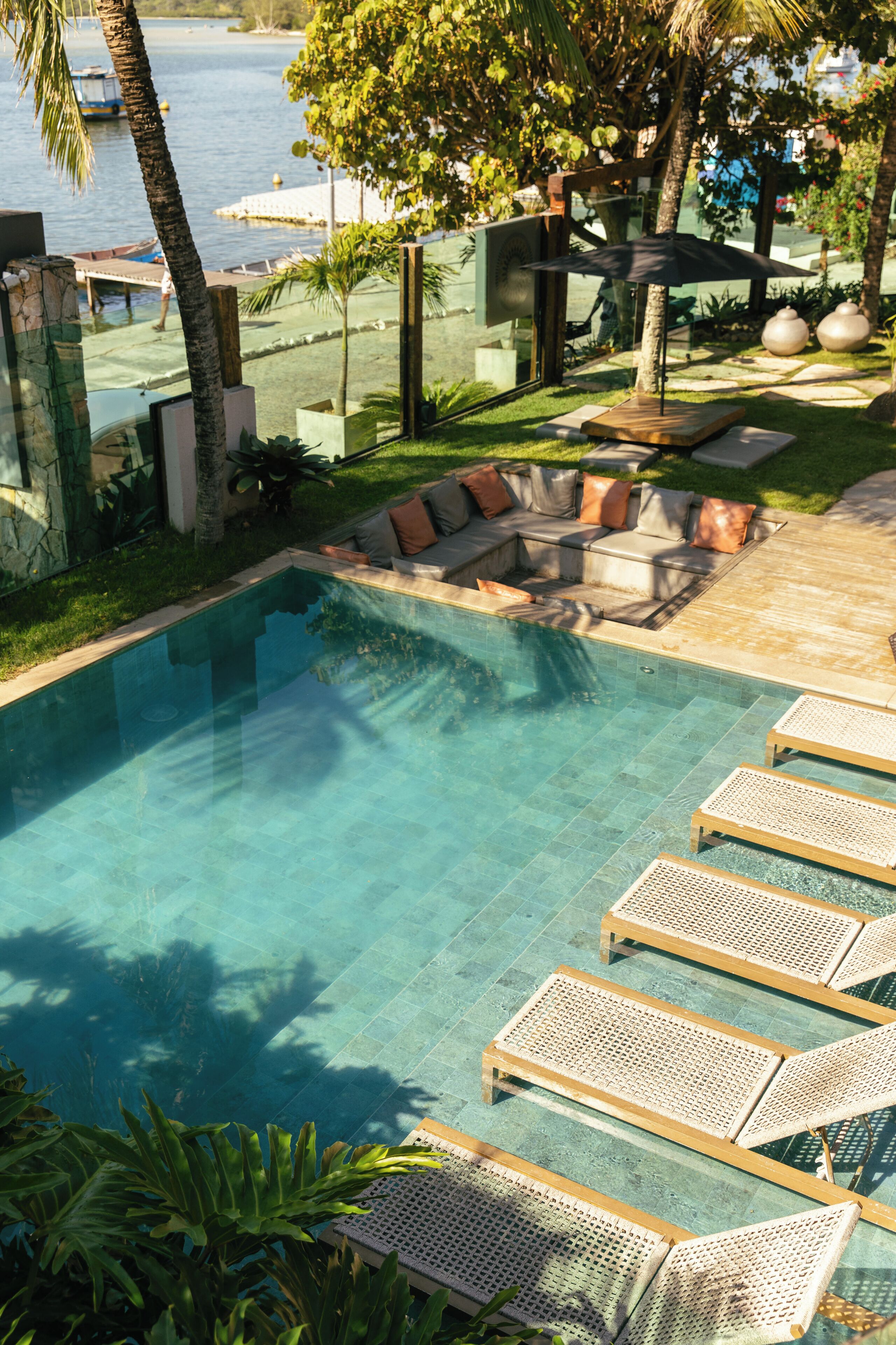 A swimming pool with lounge chairs and a seating area.
