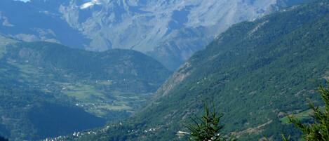 A mountainous landscape with a village nestled in the valley.