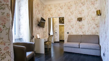 Deluxe Suite | Living area | 40-inch flat-screen TV with satellite channels, TV