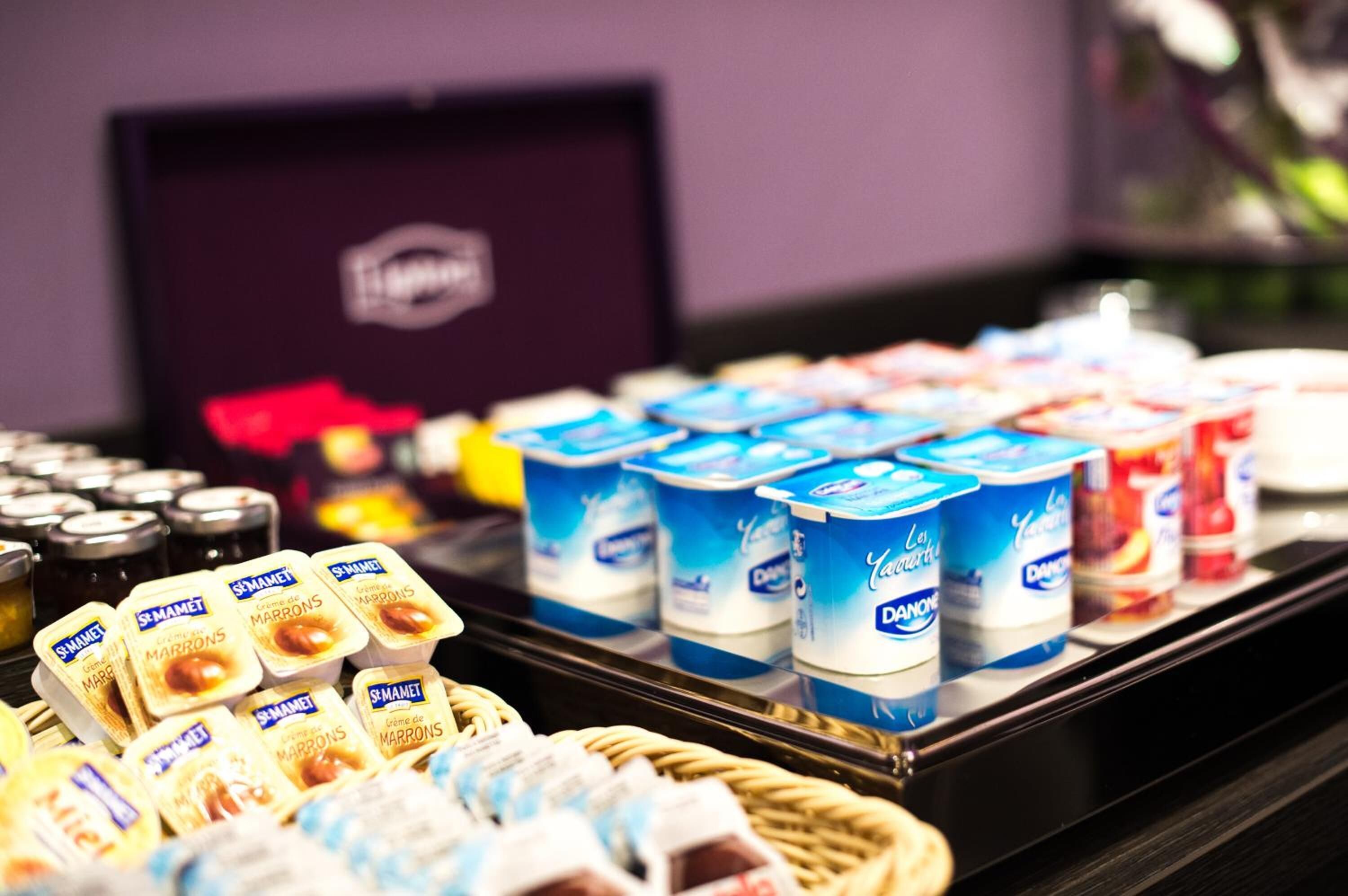 A selection of dairy products including yogurt and cheese in a refrigerated display.
