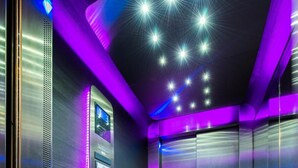 An elevator with purple LED lighting, a control panel, and a metallic finish. - Hôtel Eurocentre Toulouse Nord 3 Stars (Castelnau-d'Estretefonds)