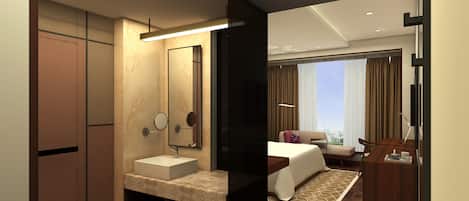 A modern hotel room with a large bed, a bedside table, a desk, and a bathroom with a sink and mirror.