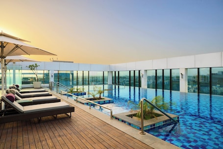 Outdoor pool, sun loungers. Renaissance Ahmedabad SG Highway