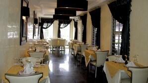 A restaurant with multiple tables, each set with wine glasses and cutlery. - Calabar Harbour Resort SPA (Calabar)
