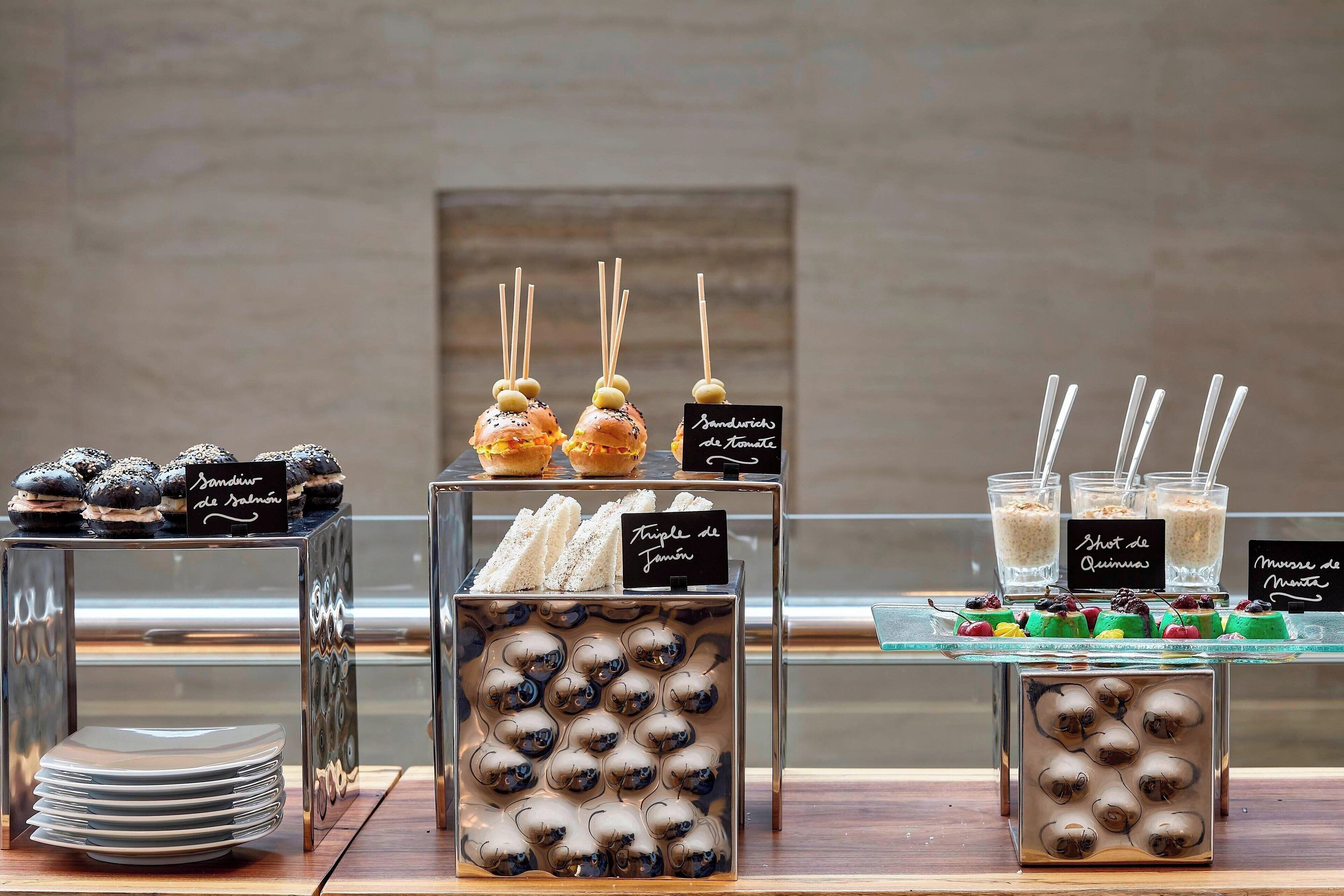 A dessert display with various treats and labels in a restaurant setting.