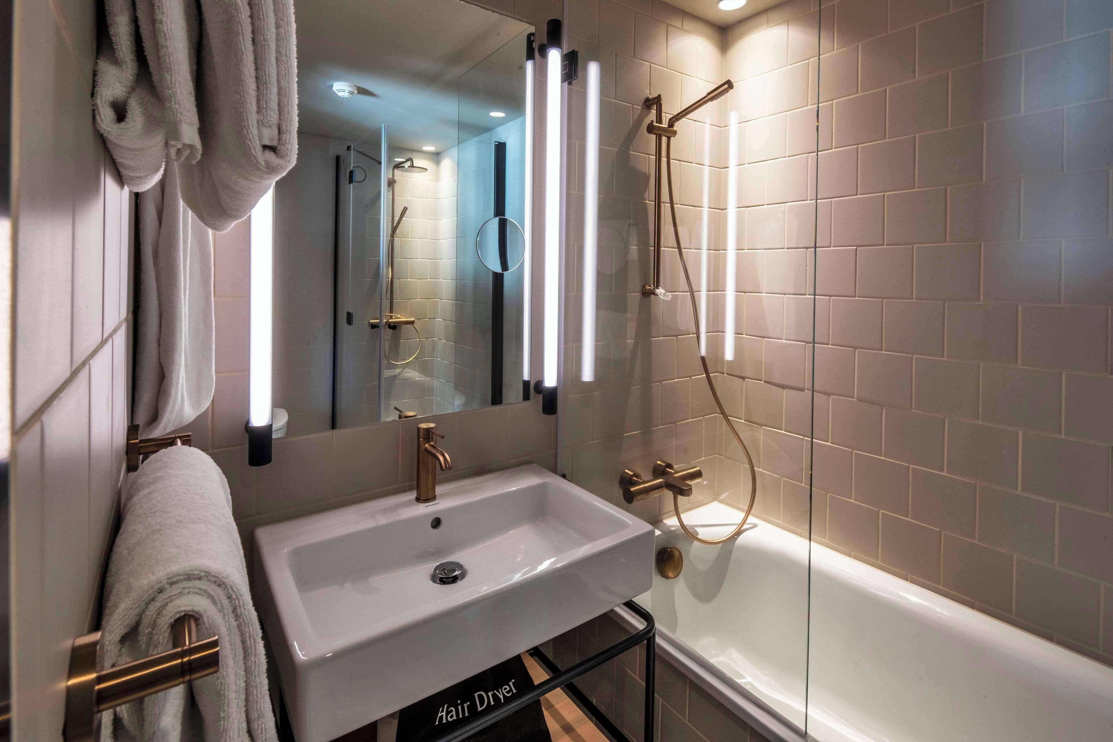 shower, designer toiletries, hair dryer, towels