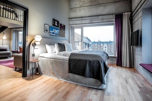 A modern hotel room with a large bed, a desk, a chair, and a window with curtains. - Scandic Kødbyen (Copenhagen)
