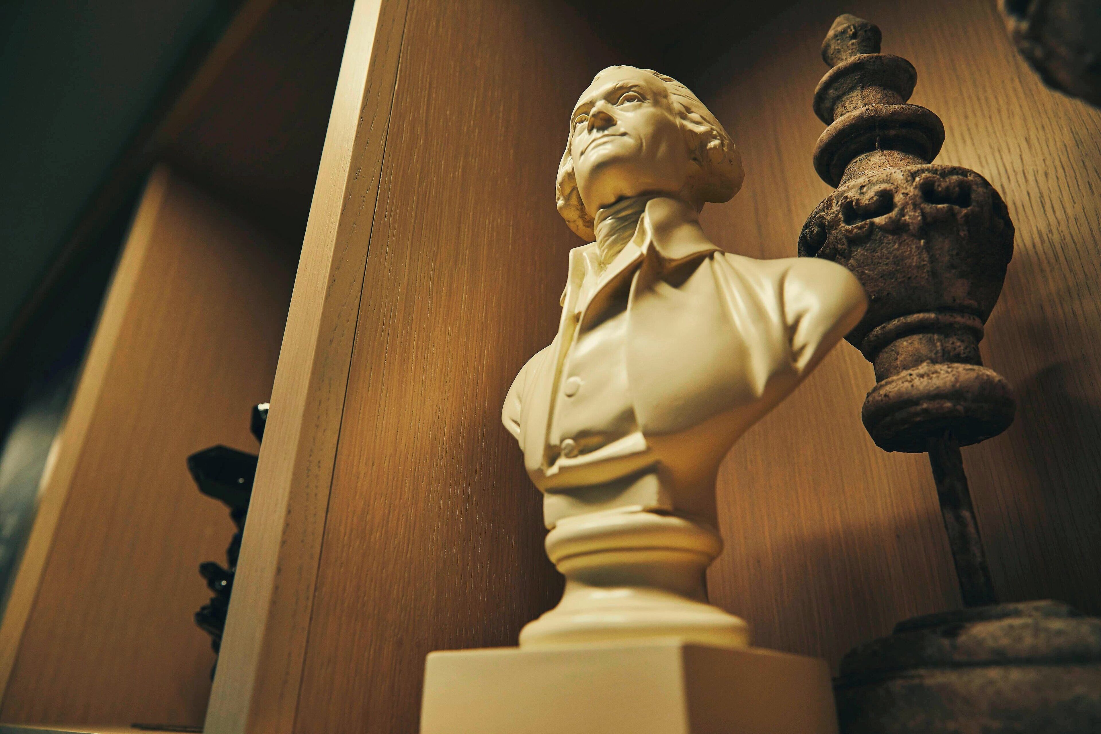 A bust sculpture on a pedestal.