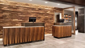 A reception area with wooden panel walls and two reception counters.