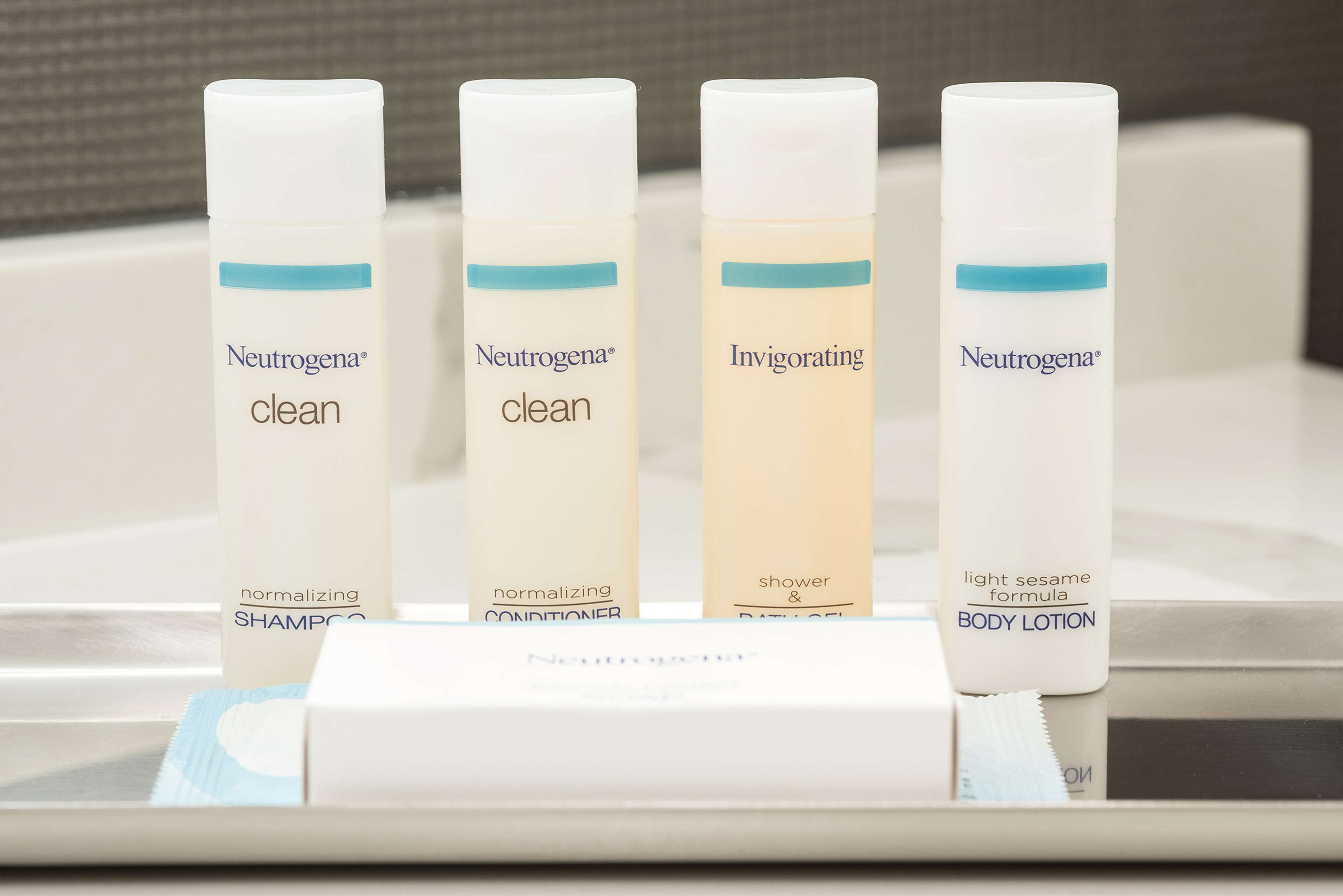 Four Neutrogena products: two 'clean' shampoos, one 'Invigorating' shower & bath gel, and one 'light sesame formula' body lotion.