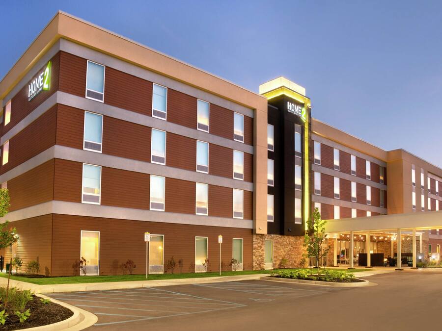 A multi-story hotel with a modern design, featuring a prominent entrance and a covered outdoor area.