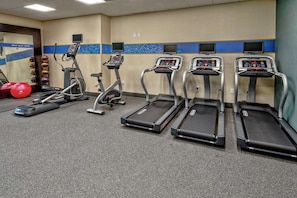 Stay active with our fitness room, featuring treadmills, a stationary bike, and exercise equipment for a variety of workouts.