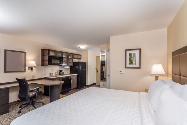 A hotel room with a bed, desk, kitchenette, and a bathroom. - Candlewood Suites Bensalem - Philadelphia Area by IHG (Feasterville-Trevose)