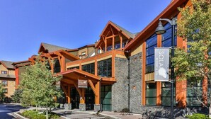 A modern building with a reception area, large windows, and a sign for 'SOLAR RESORT & SPA'. - Bow 221 | Resort Suite with Pool & Hot Tub (Canmore)