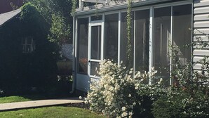A house with a covered porch, a screened window, and a well-maintained lawn. - The Rustic Old Farmhouse Peaceful home in Amish country,10 min from tourist area (Gap)