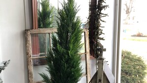 A rustic wooden dresser with a mirror, a small Christmas tree, and a decorative lantern. - The Rustic Old Farmhouse Peaceful home in Amish country,10 min from tourist area (Gap)