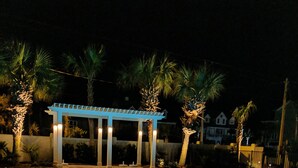 A swimming pool with a pergola and palm trees in the background. - MARLIN QUAY,  2 BR , 2  bath , Unit 205, ELEVATOR,  Pools, overlooks Marina<br> (Murrells Inlet)