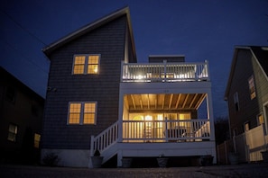 A two-story house with a balcony and a porch.