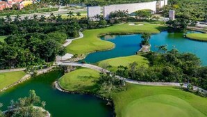 A golf course with multiple water hazards and a large central green.