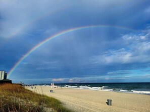 A beach with a visible rainbow, sandy shore, and ocean waves. - APATBIII Ocean Side/Ocean View 9520 SHORE DR 3P Family friendly.  (Myrtle Beach)