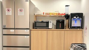 A compact kitchenette with a refrigerator, microwave, coffee maker, and a small refrigerator. - JAKOTEL Plus Namba (Osaka)