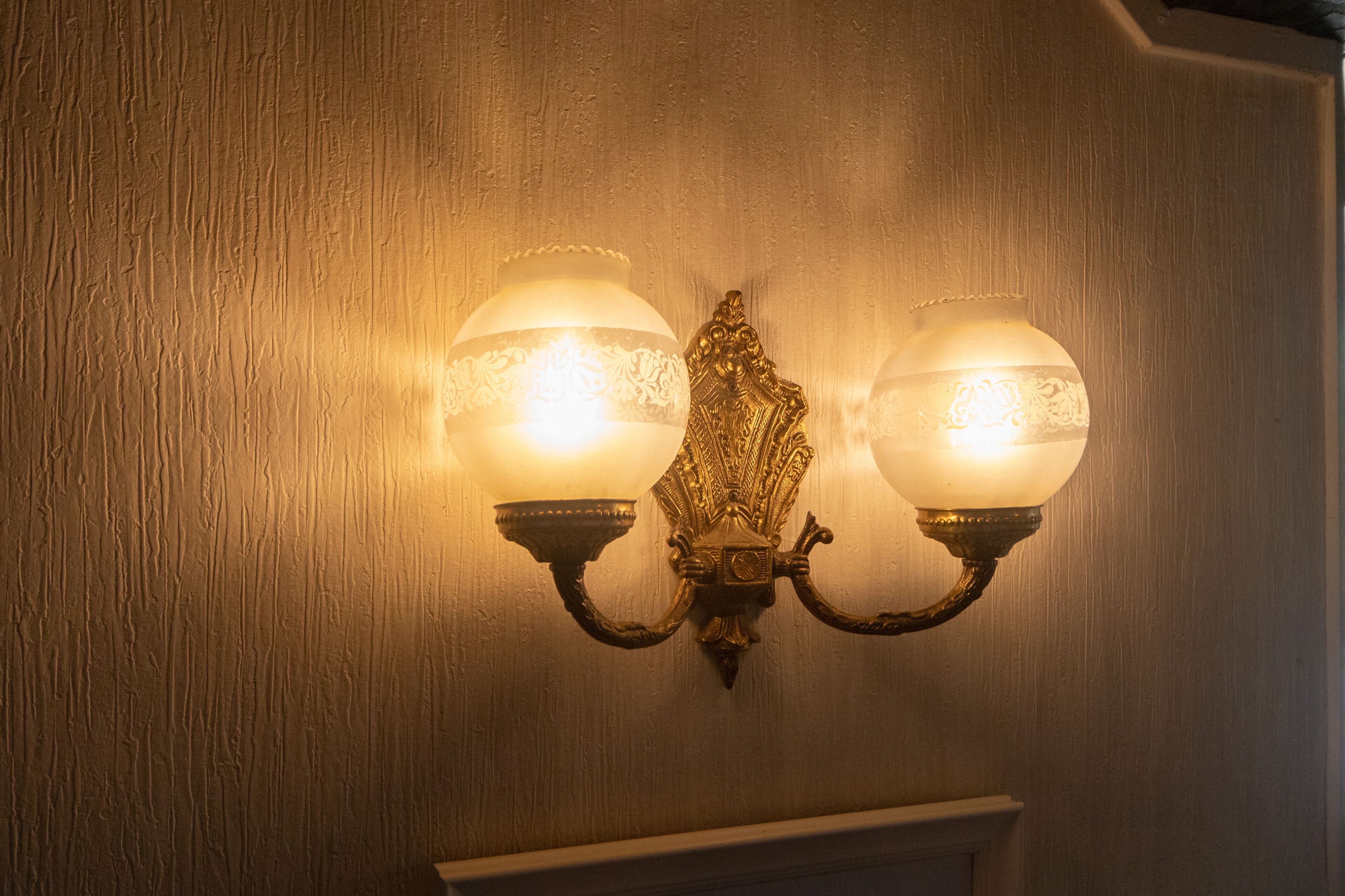 A wall-mounted light fixture with two lamps.