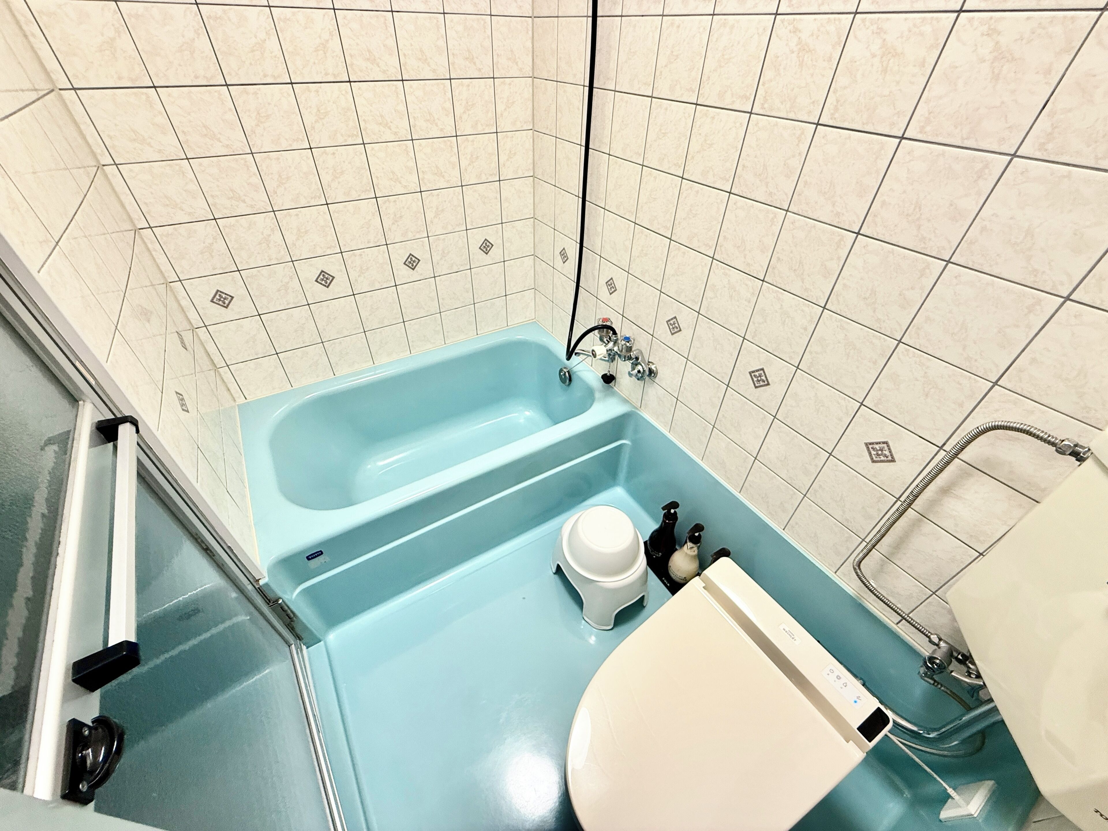 A bathroom with a bathtub, a toilet, and a shower.