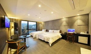A hotel room with two beds, a desk, a chair, a TV, and a view of the city. - Anyang Boutique Hotel AMA (Anyang)